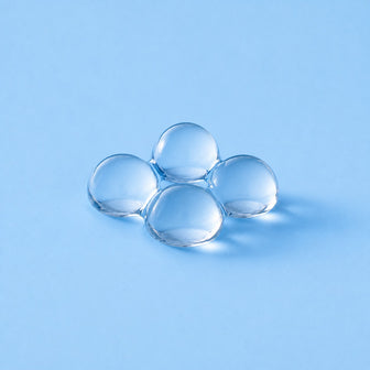Xylitol pearls on a sky-blue studio ground