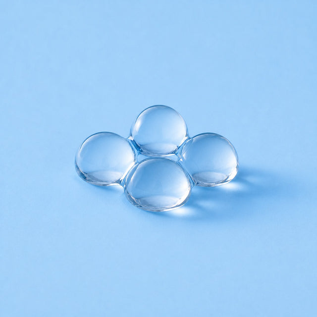 Xylitol pearls on a sky-blue studio ground