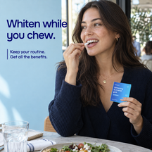 Woman placing a piece of ENAMELIFT gum in her mouth