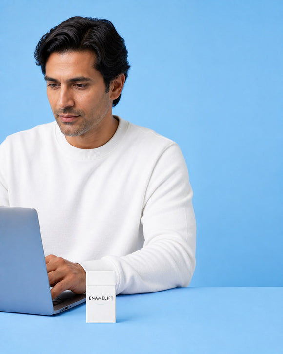 Man working at a laptop with an ENAMELIFT pack on the desk