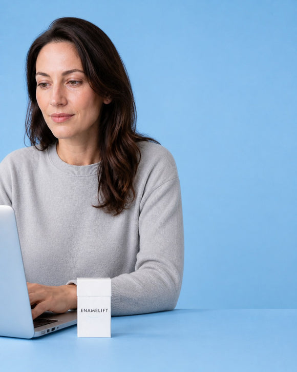Woman working at a laptop with an ENAMELIFT pack on the desk