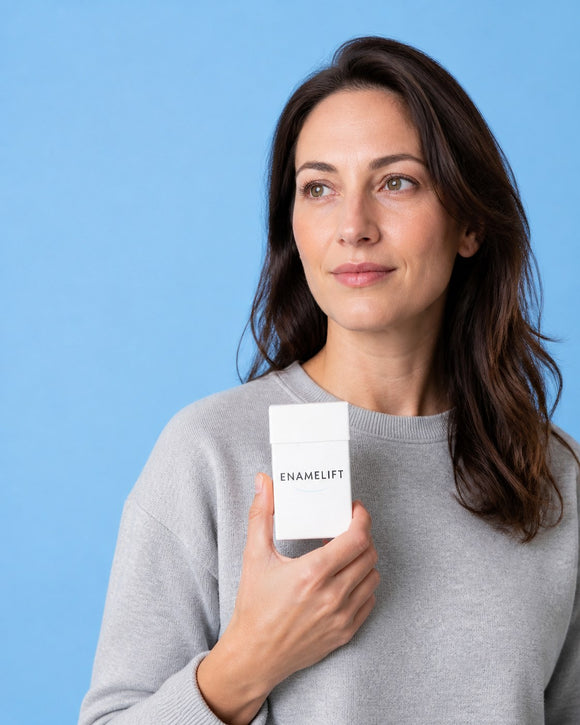 Woman holding an ENAMELIFT pack against a sky-blue background